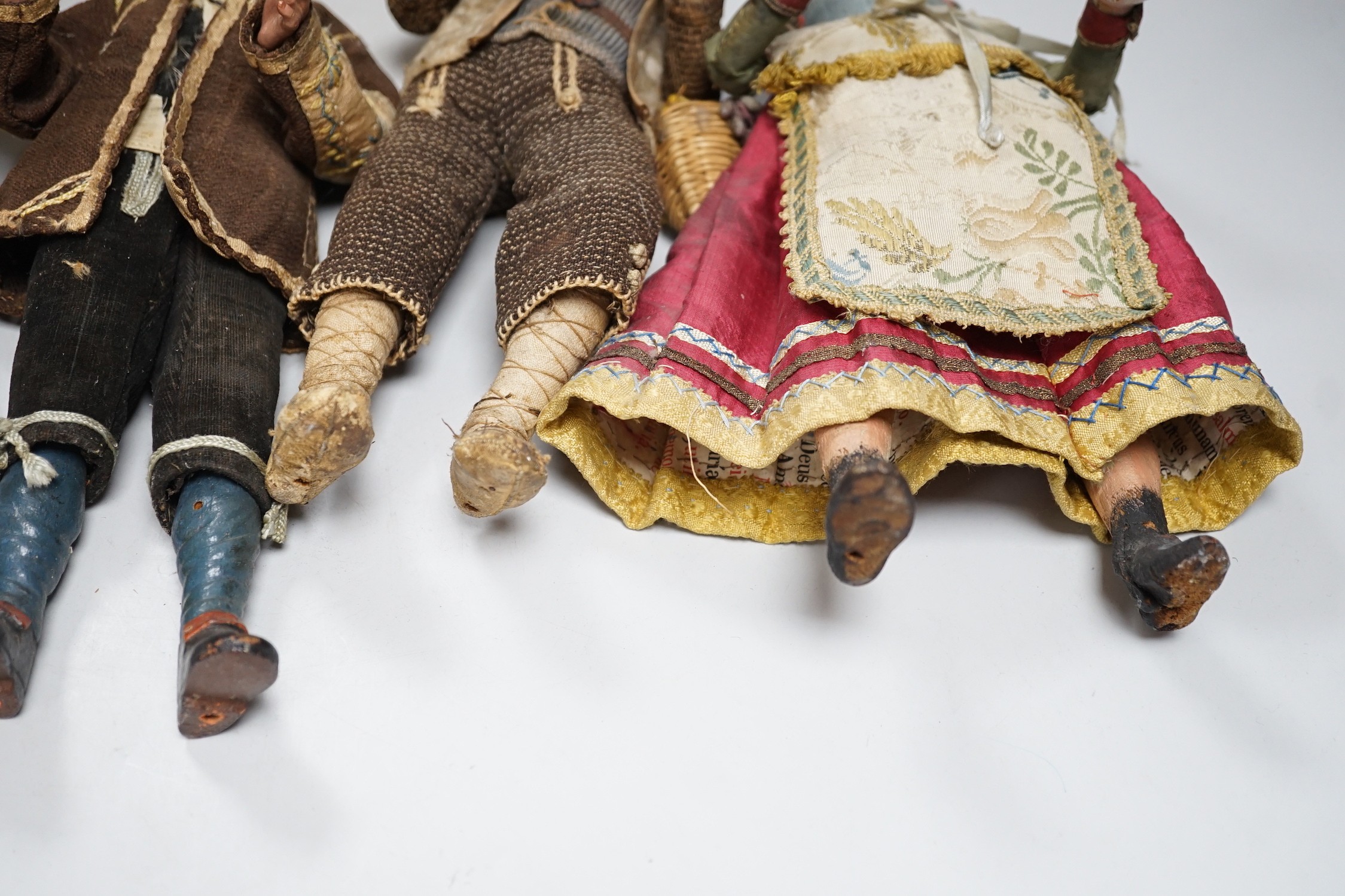 Four 18th/19th century Neapolitan painted wood or terracotta crèche figures, tallest 31.5cm and a 20th century miniature Bauernschrank
